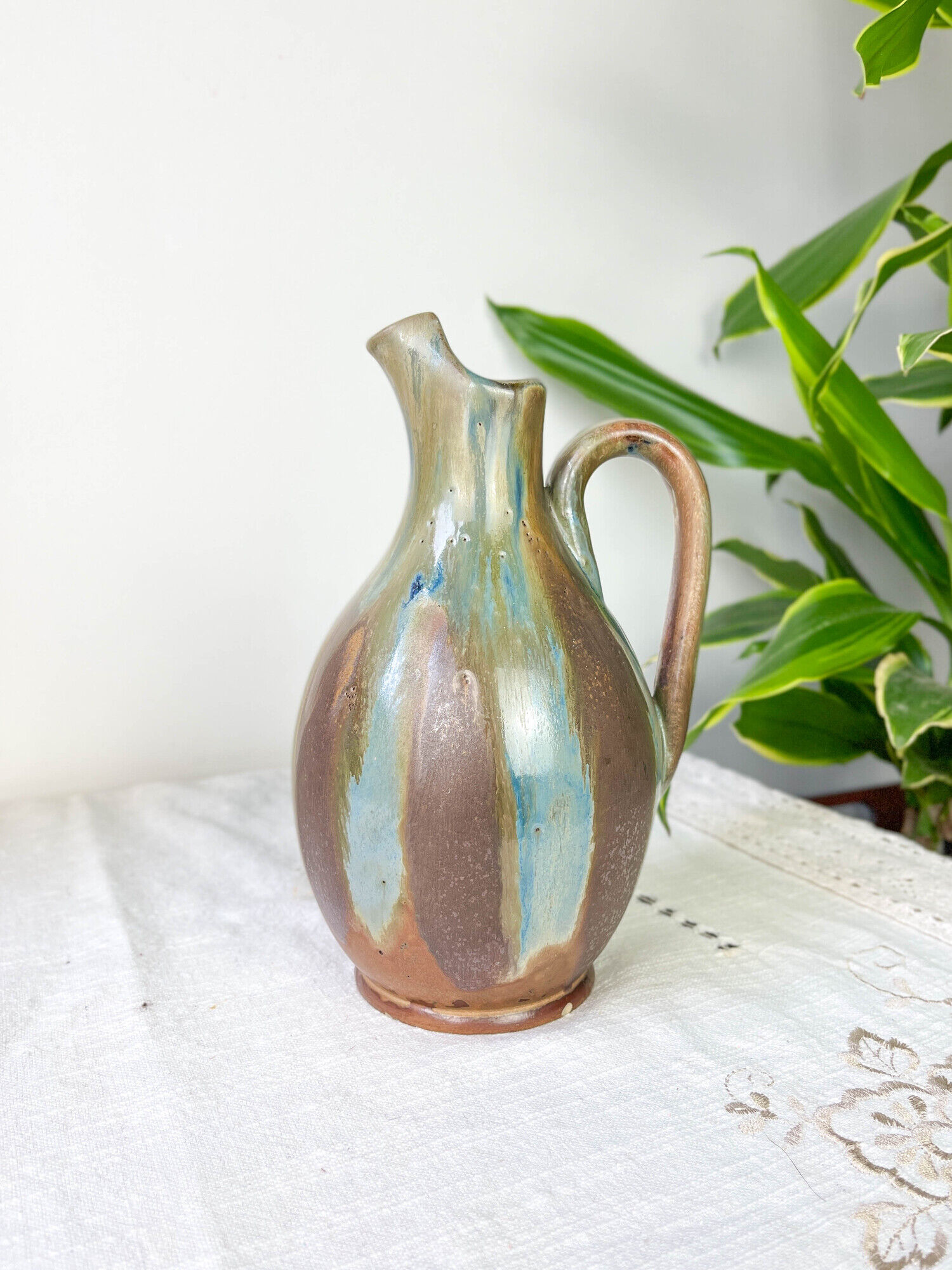 Art Nouveau style carafe in flamed stoneware with blue and brown drips