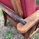 Morris chair with wooden frame and burgundy cushions.