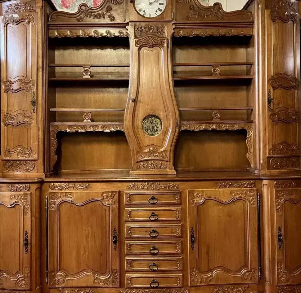 Important buffet deux-corps Louis XV galbé en merisier avec horloge intégré
