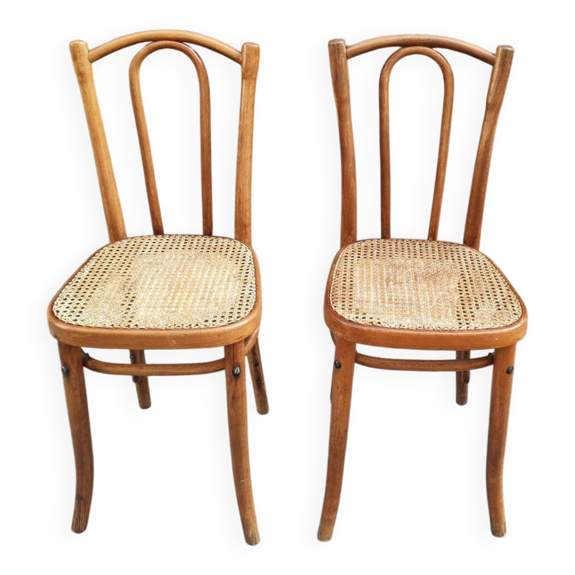 Pair of vintage bistro chairs in curved wood and caning.