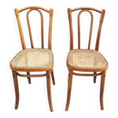Pair of vintage bistro chairs in curved wood and caning.
