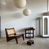 Reclined armchair in canned teak in natural wood