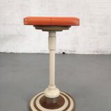 Old swivel orange sitting dentist stool