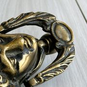 Large antique style brass metal knocker.