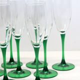 8 large green stem champagne flutes in very good condition.