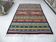 Traditional Berber tribal kilim rug with multicoloured geometric patterns.