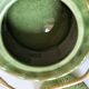 Vintage green teapot with lotus decoration and bamboo handle.
