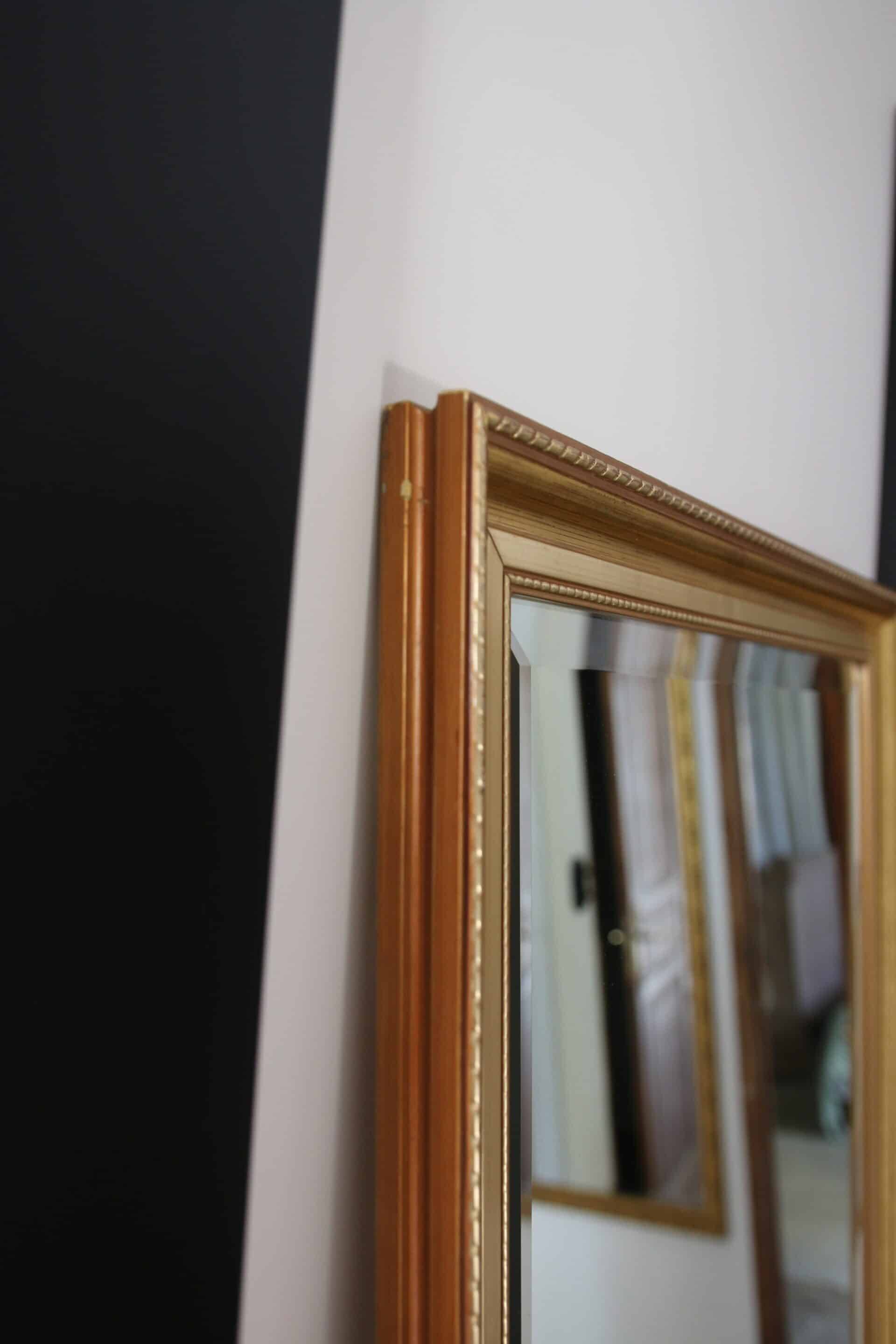 Large beveled mirror in carved wood