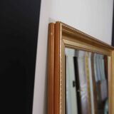 Large beveled mirror in carved wood