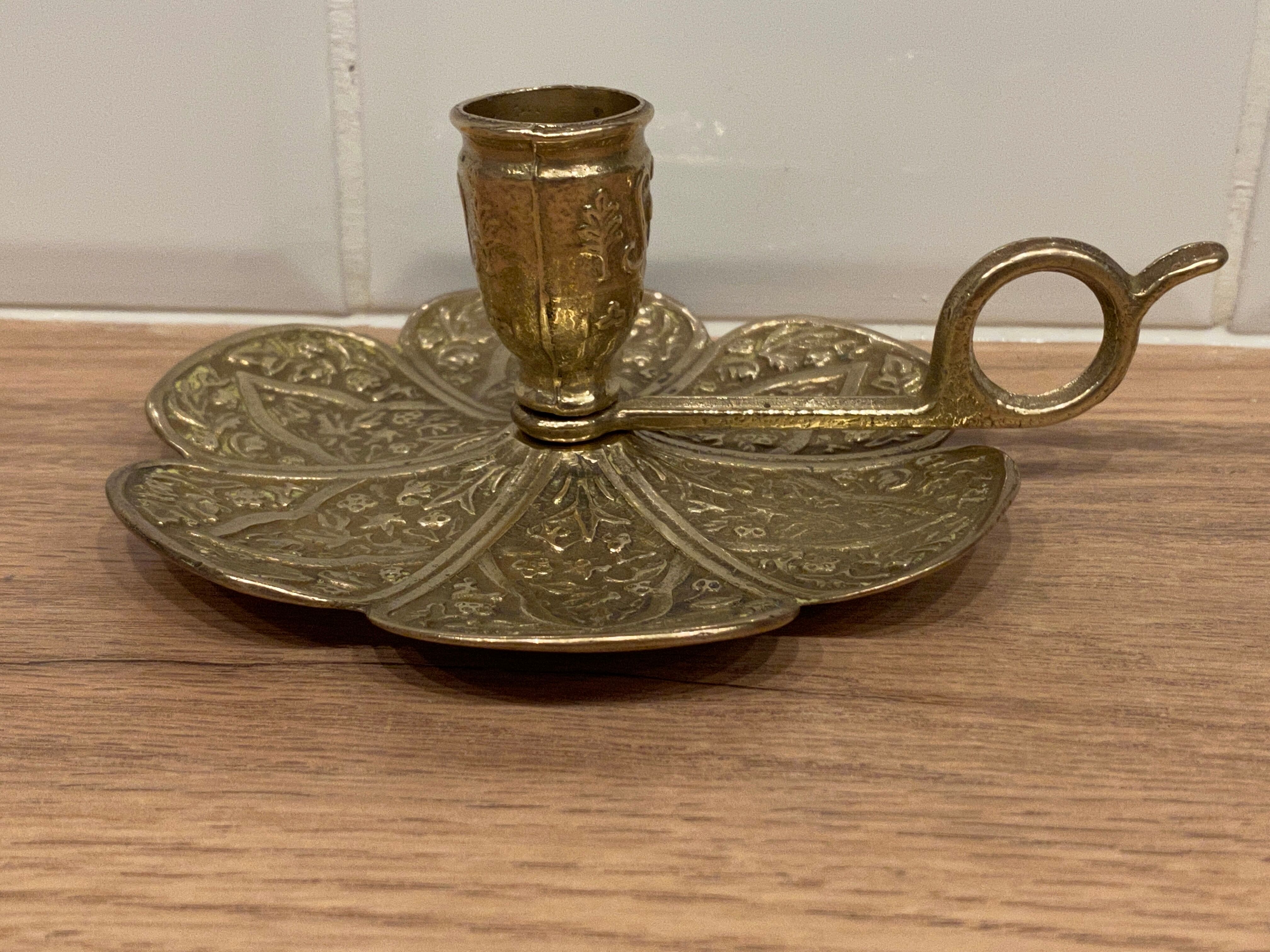 Brass candle holder on frame