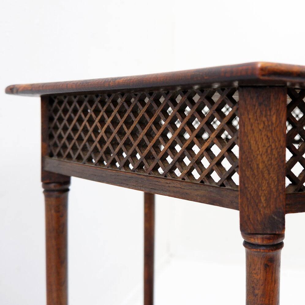 Hexagonal pedestal table or side table with a lattice structure and star pattern.