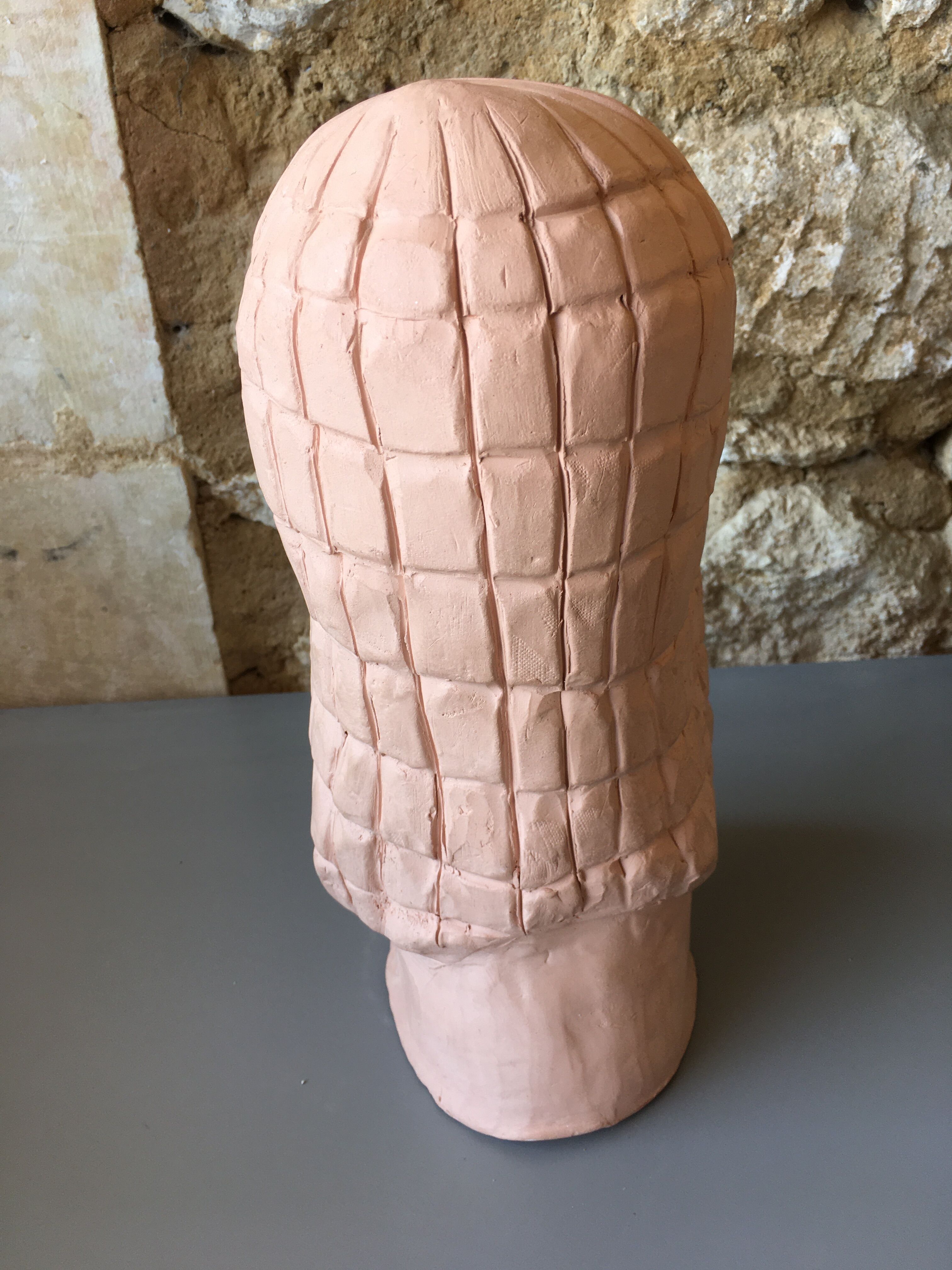 Bust of lady with hood in terracotta