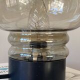 Sciolari table lamp with smoked glass globe and black plastic base.