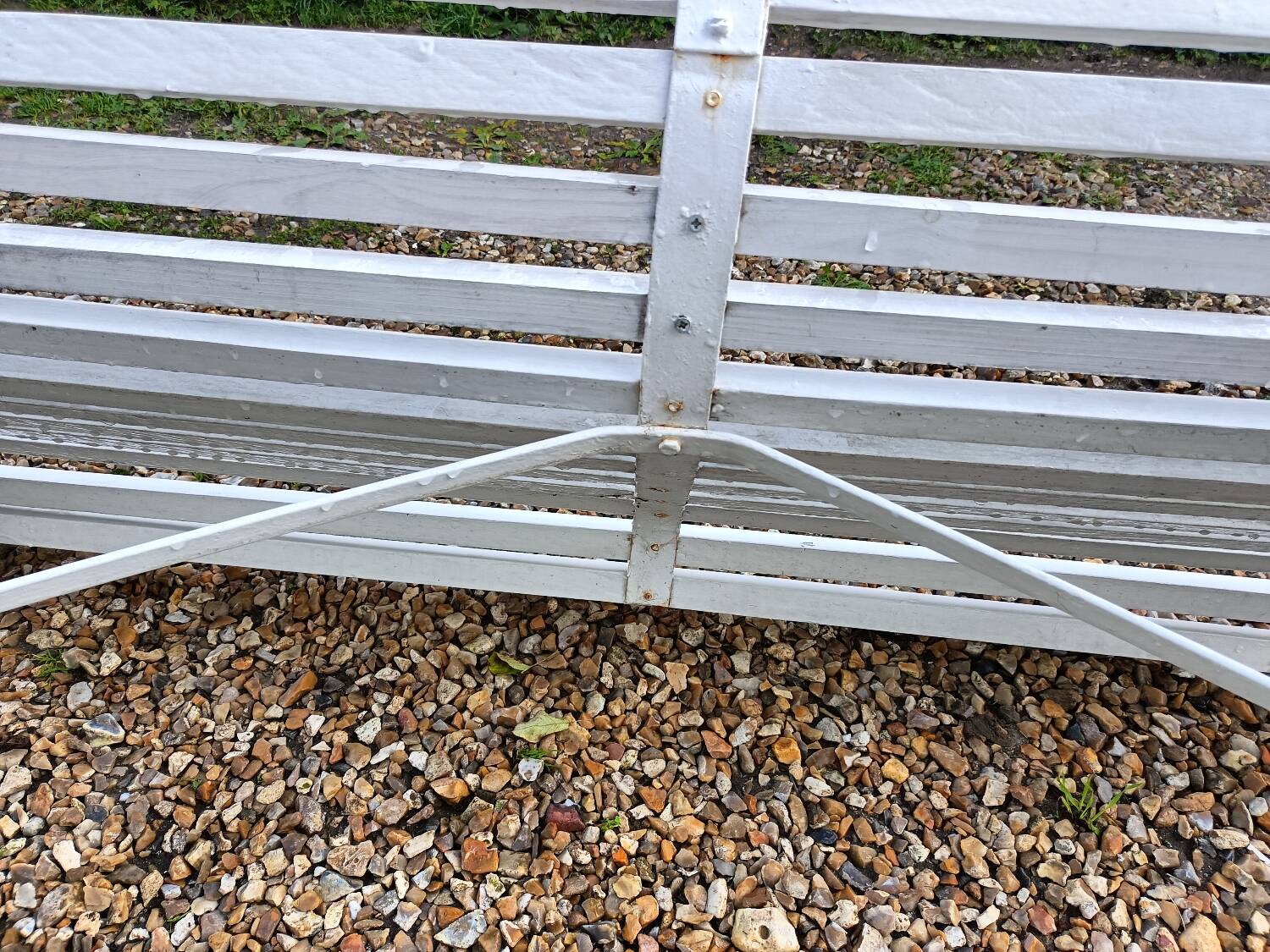 Old garden bench with metal legs and wooden slats