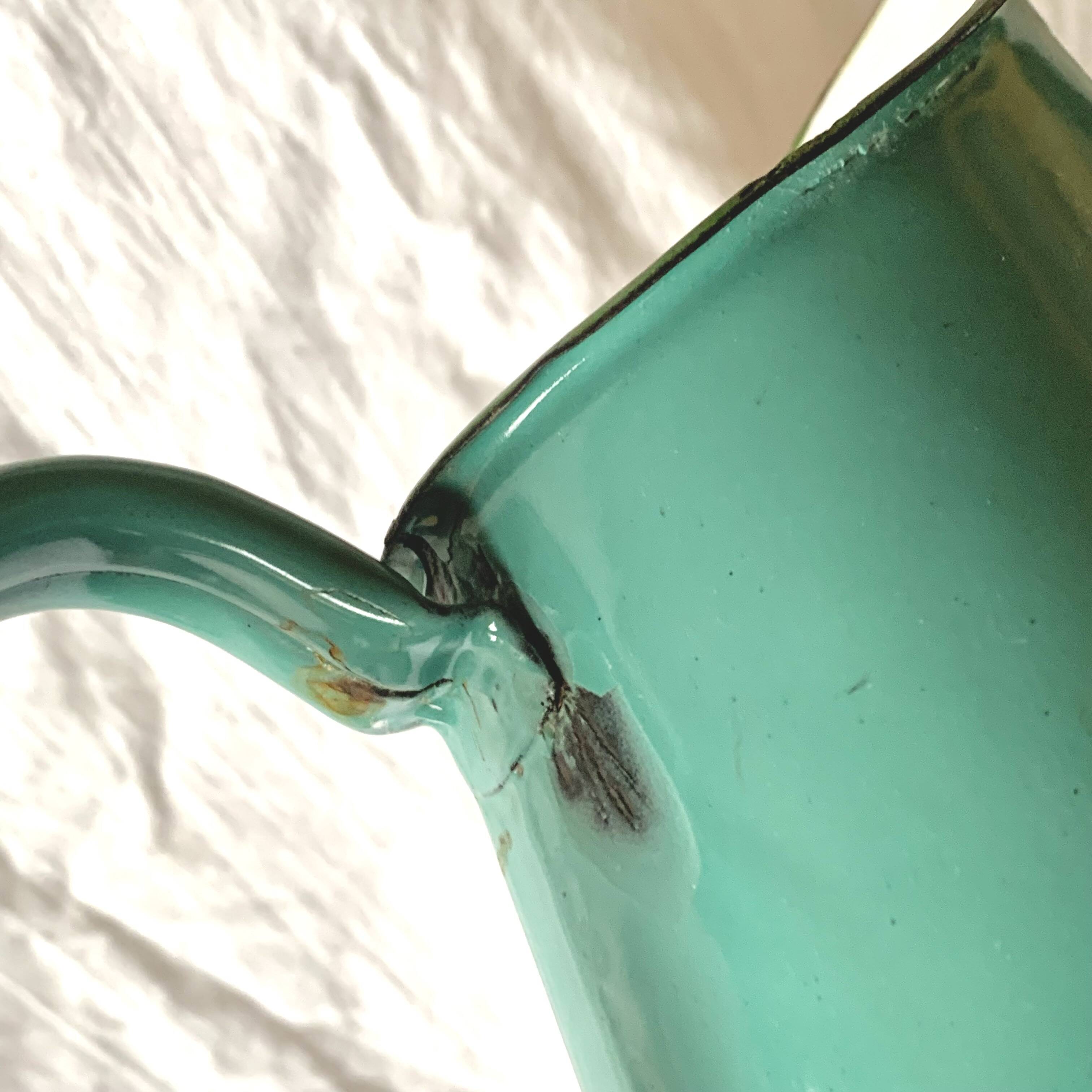 Vintage pitcher in green enameled sheet metal