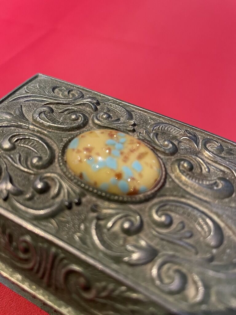 Ancient box made of chiseled metal and stone