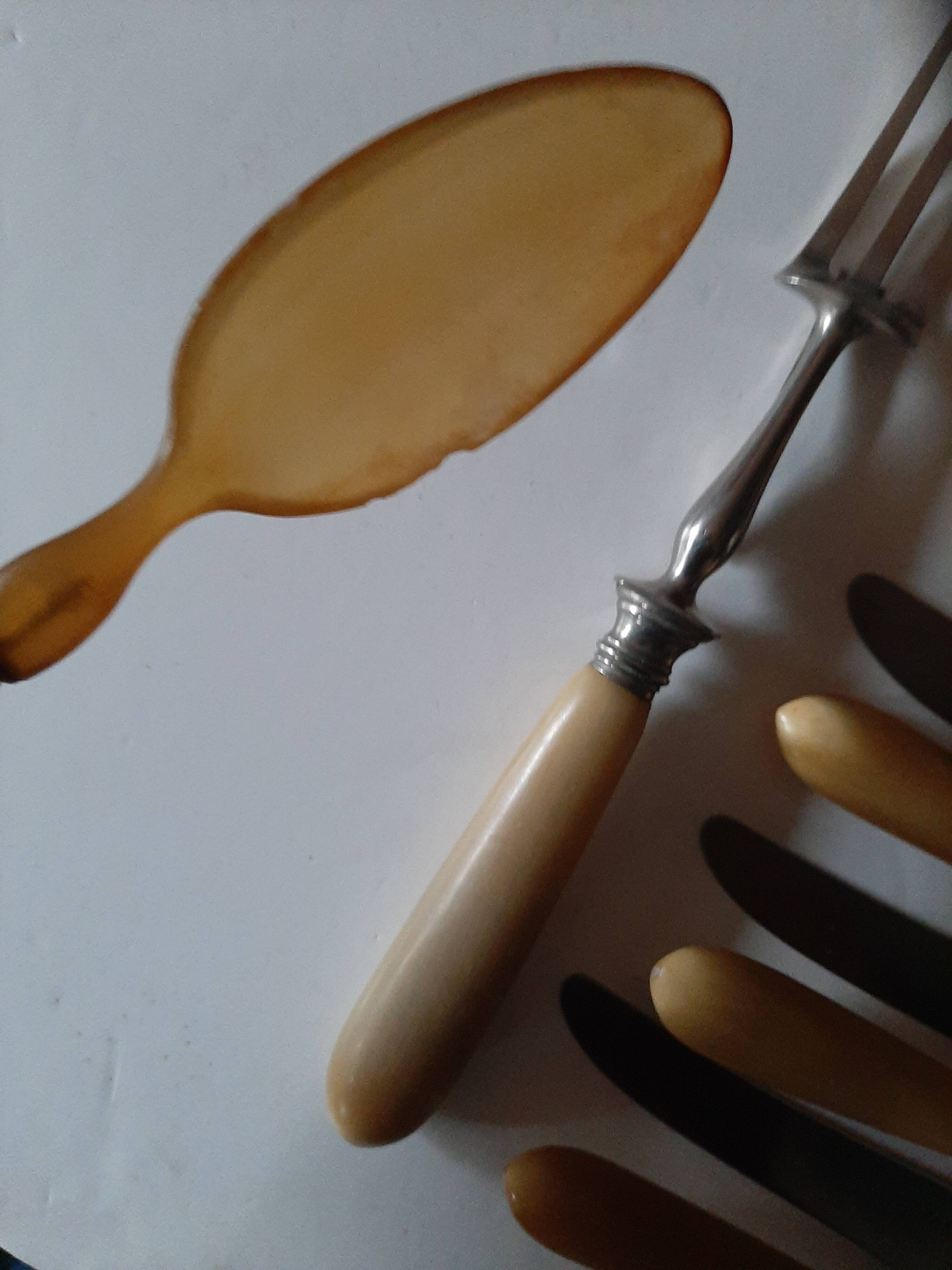 29-piece horn cutlery set, knives and serving utensils.