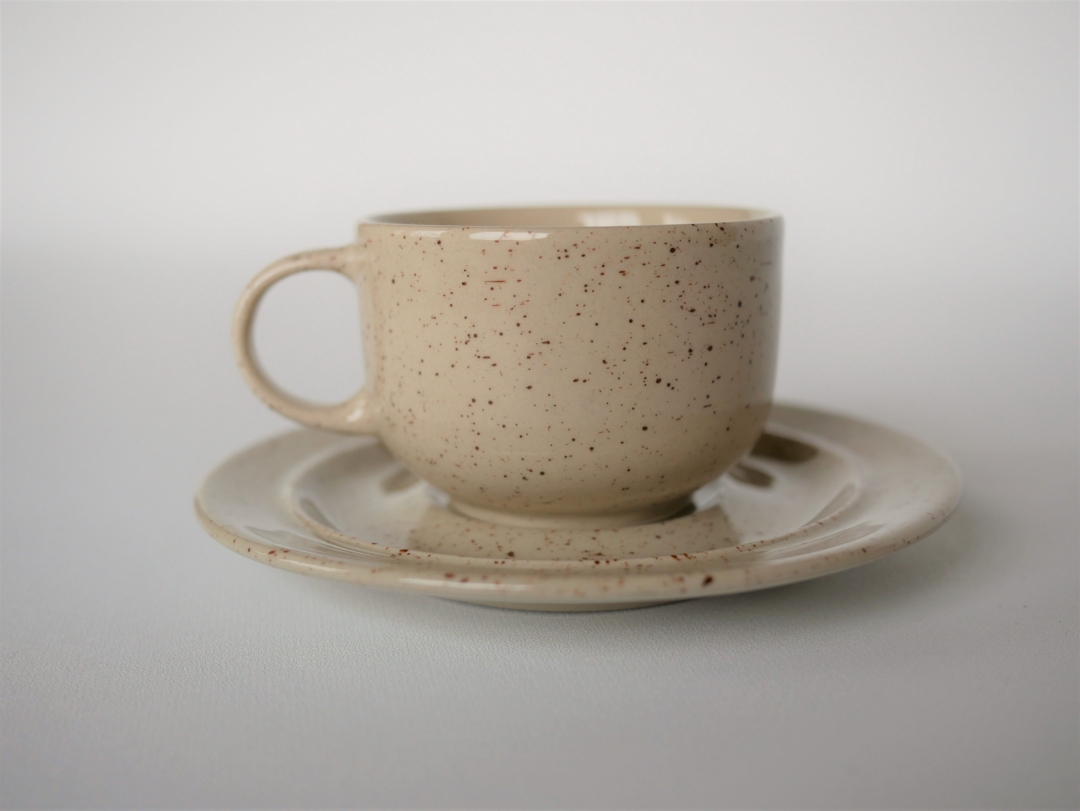 Coffee cup and vintage pyrity sandstone subcup