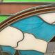 Art Deco stained glass window decorated with a 20th century church steeple