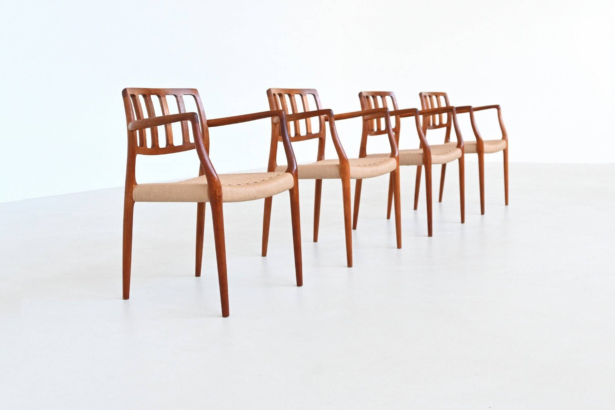 Niels Otto Moller model 66 armchairs teak and paper cord Denmark 1974
