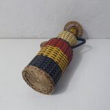 Old bottle dressed in scoubidou style rattan
