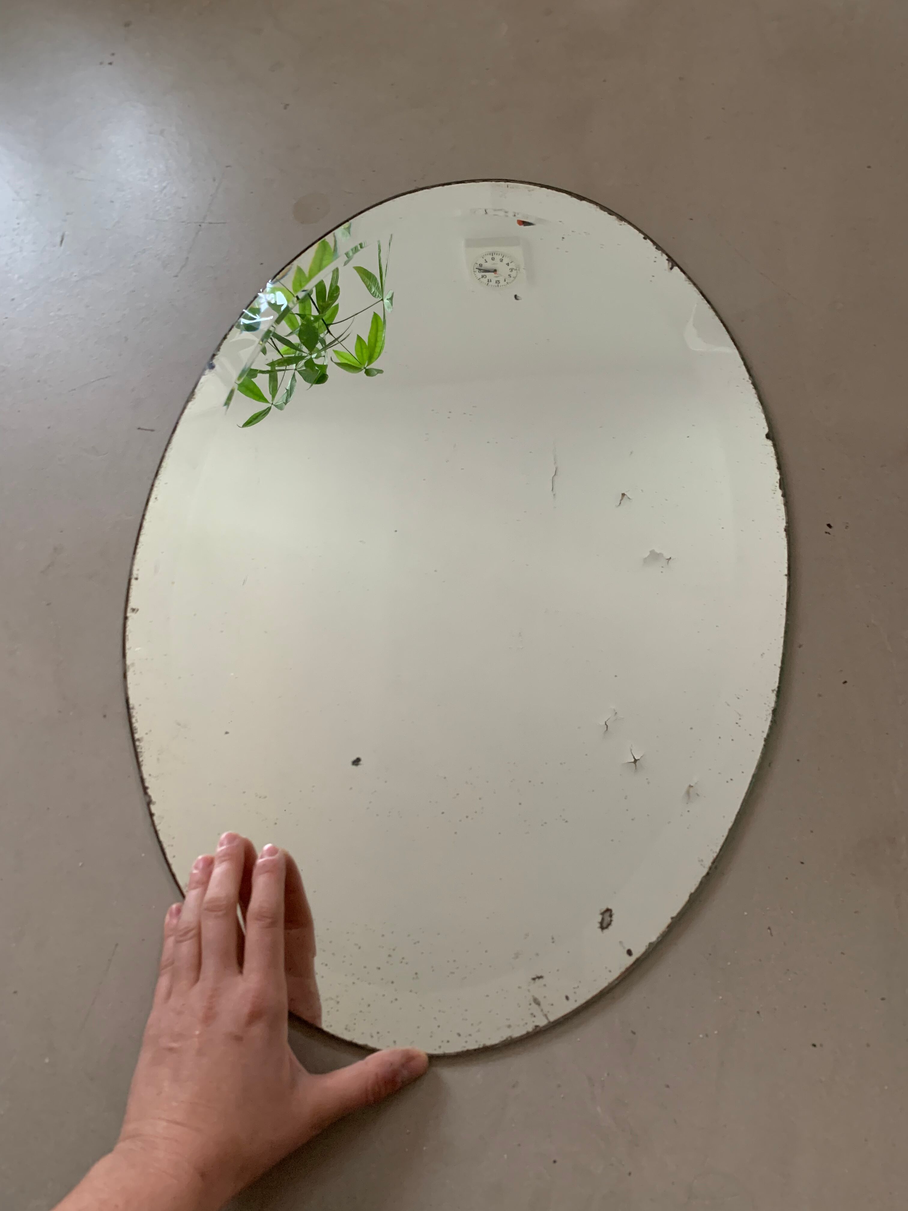 Old bevelled stitched oval mirror
