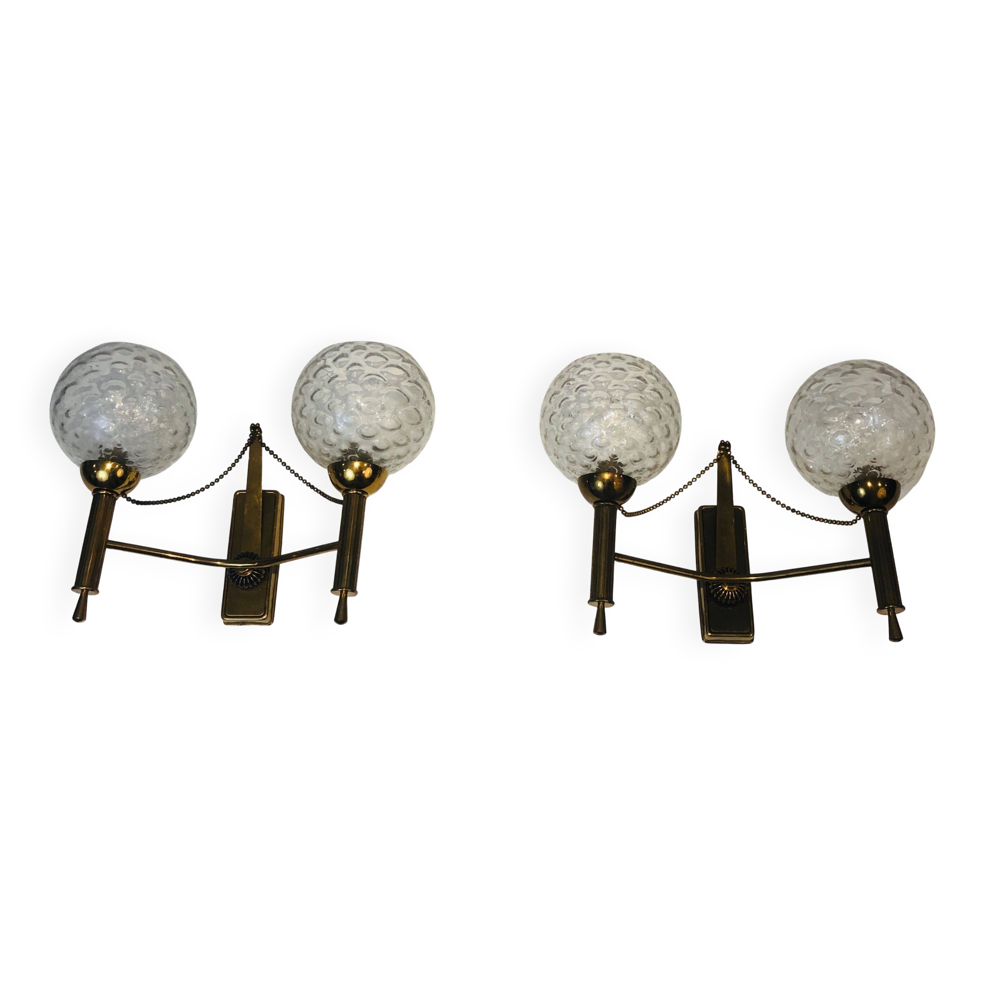 Pair of brass wall lights with glass globes. Around 1970.