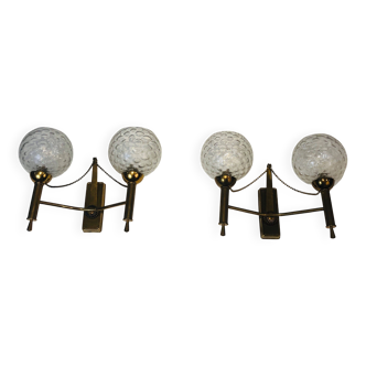 Pair of brass wall lights with glass globes. Around 1970.