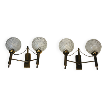 Pair of brass wall lights with glass globes. Around 1970.