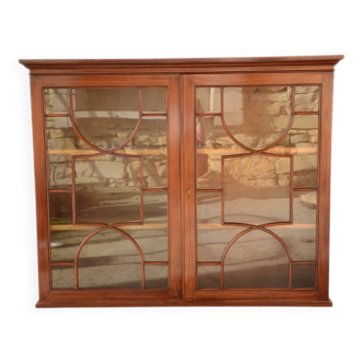 English-style glass-fronted library in mahogany veneer.