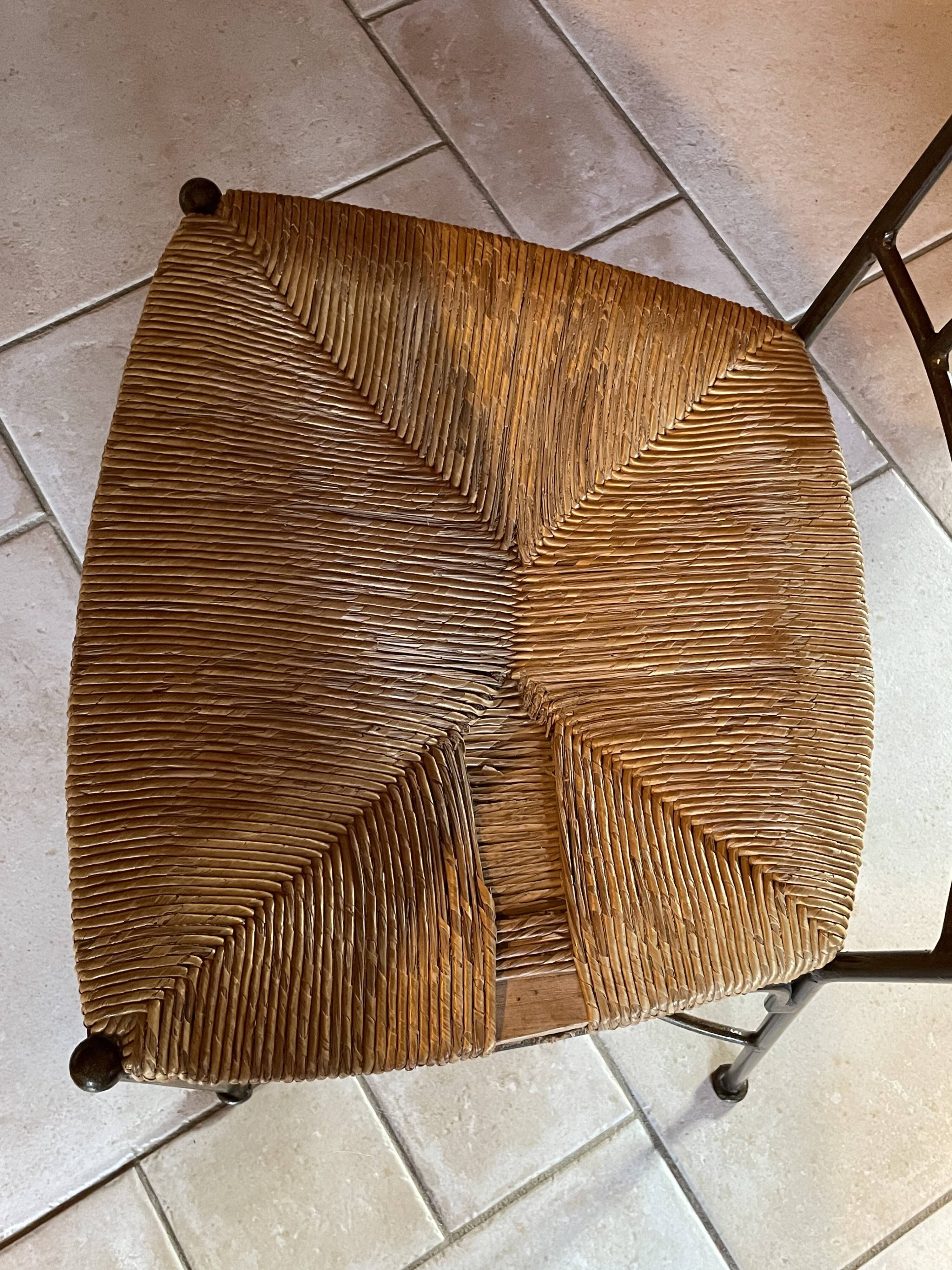Table and four wrought iron and wood chairs.