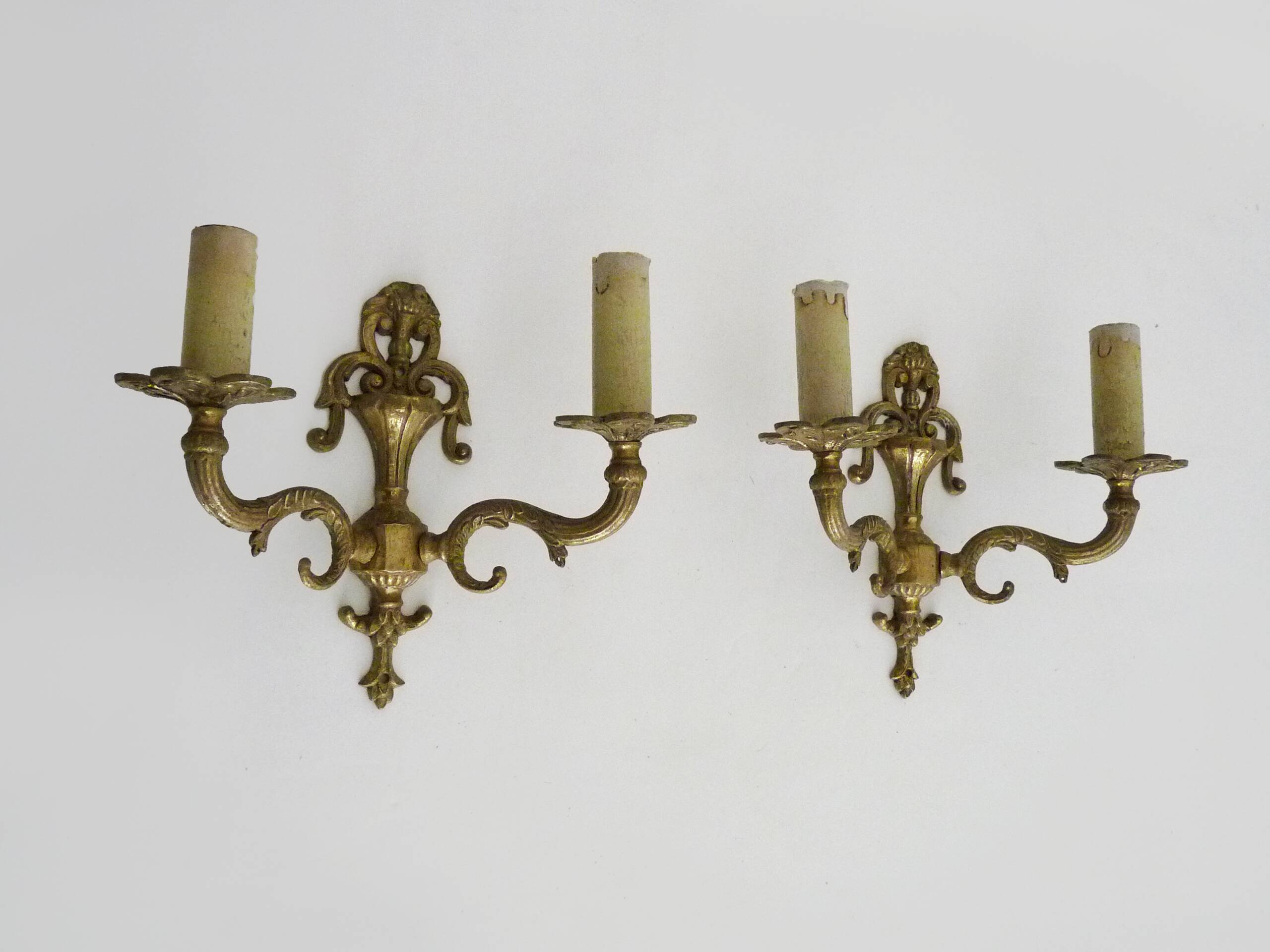 Pair of two-armed fire pot wall lights in gilded bronze.
