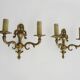 Pair of two-armed fire pot wall lights in gilded bronze.
