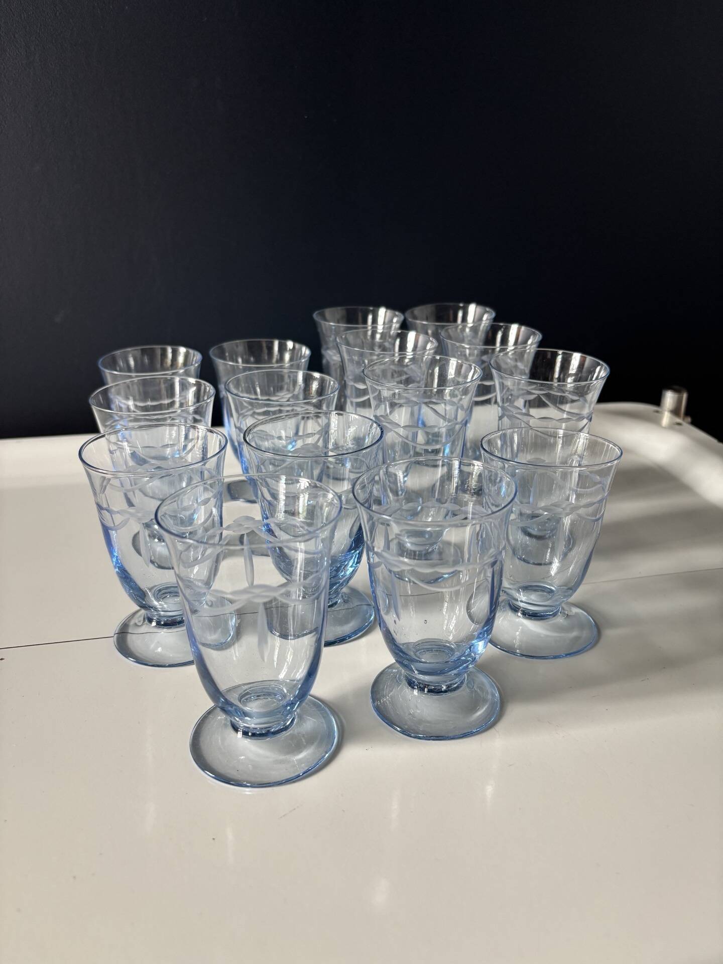 Set of 32 vintage glacier blue engraved stemmed glasses.