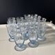 Set of 32 vintage glacier blue engraved stemmed glasses.