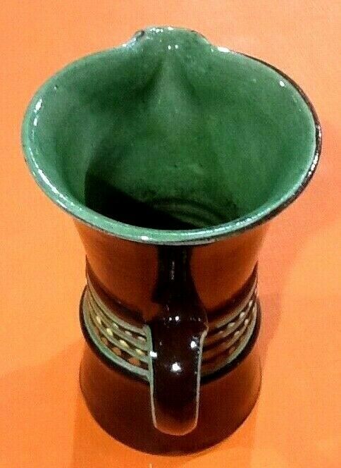 Glazed terracotta pitcher decorated with beaded friezes