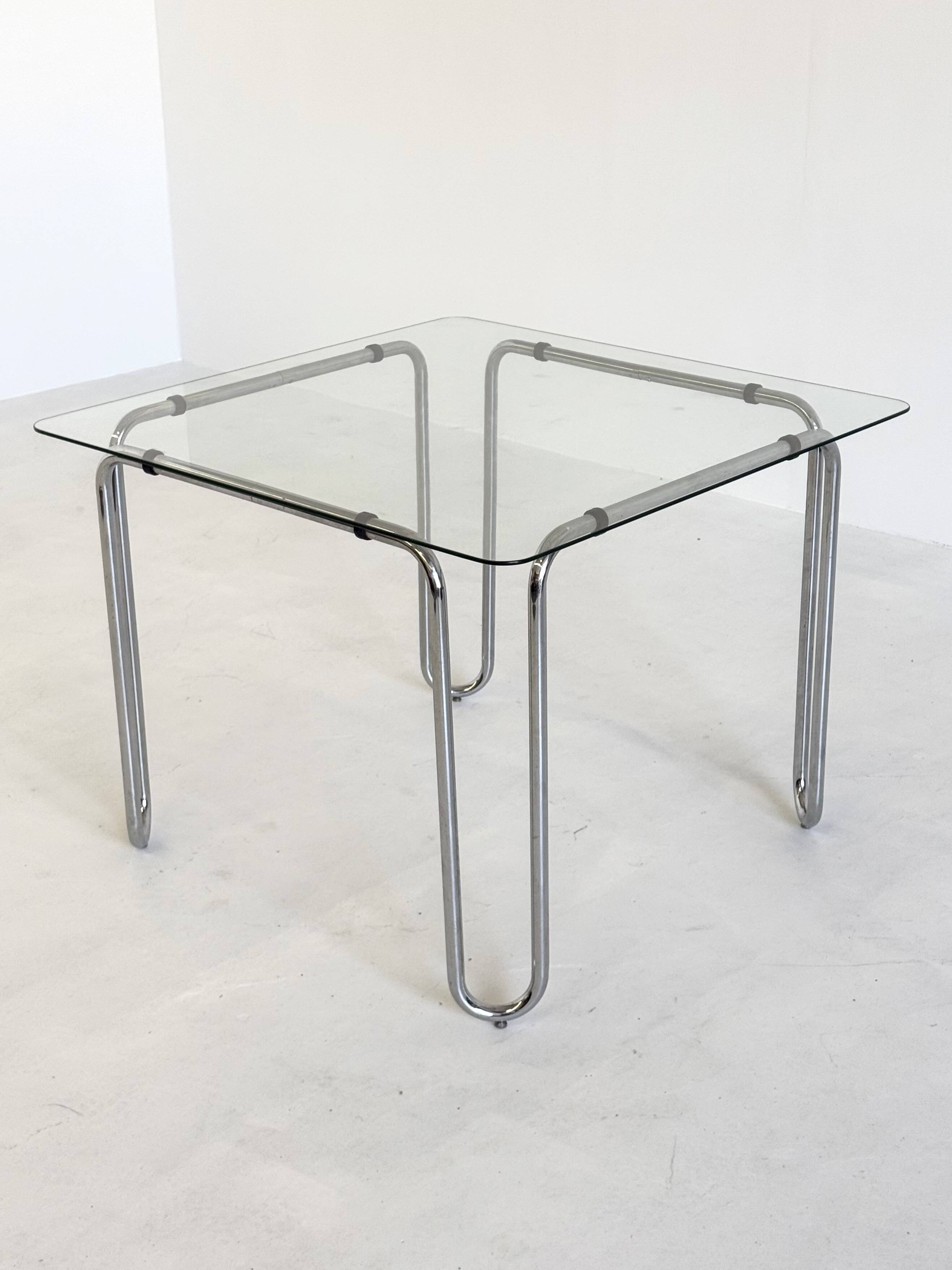 Italian vintage dining table with smooth glass and tubular frame base