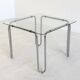 Italian vintage dining table with smooth glass and tubular frame base