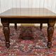 Victorian-style mahogany English table with 3 extensions.