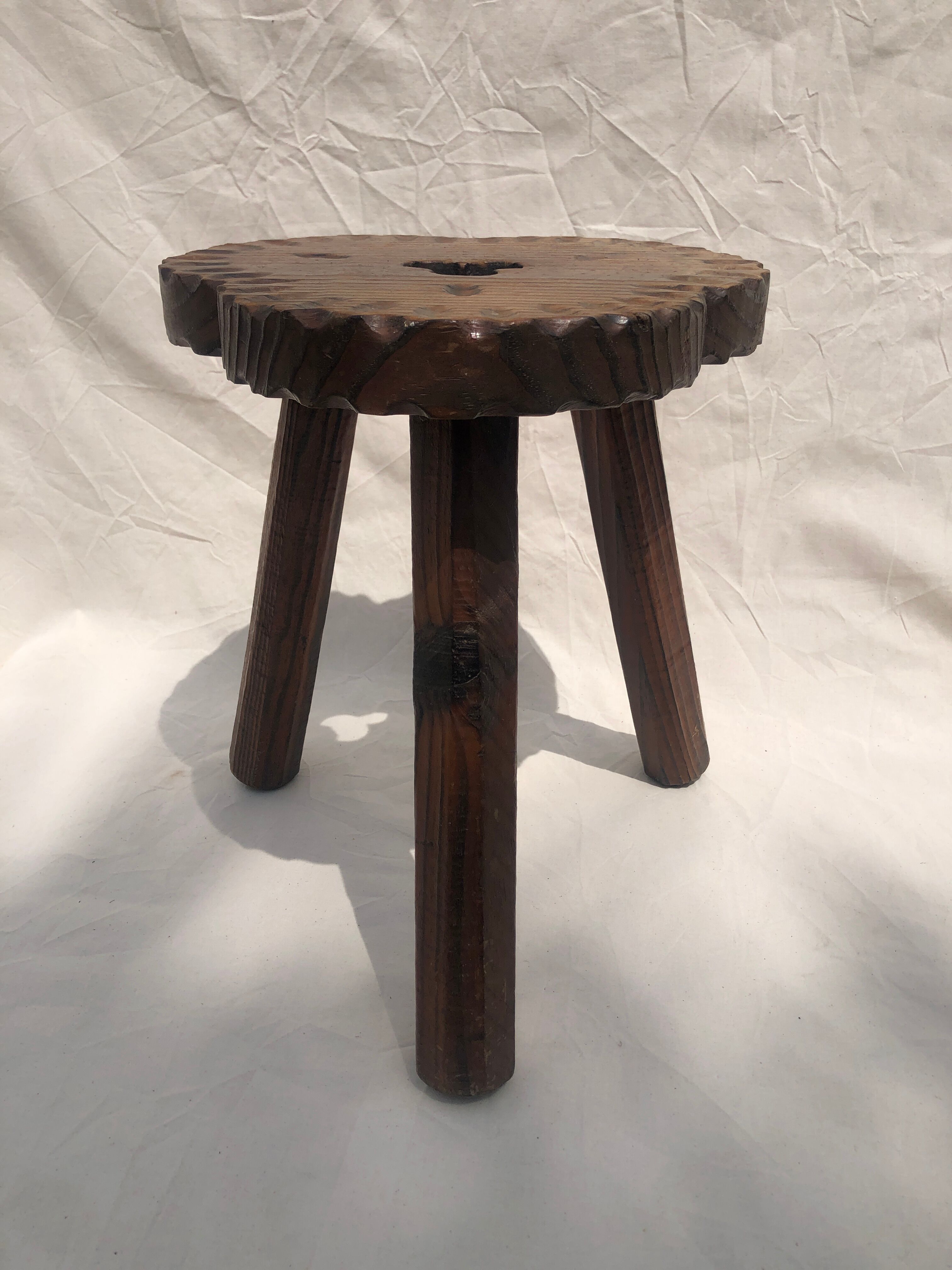 Chiseled wooden tripod stool