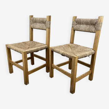 2 straw and wood chairs in brutalist style