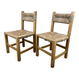 2 straw and wood chairs in brutalist style