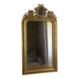 Late 19th century gilded mirror with decorated pediment. 125x70.
