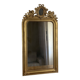 Late 19th century gilded mirror with decorated pediment. 125x70.