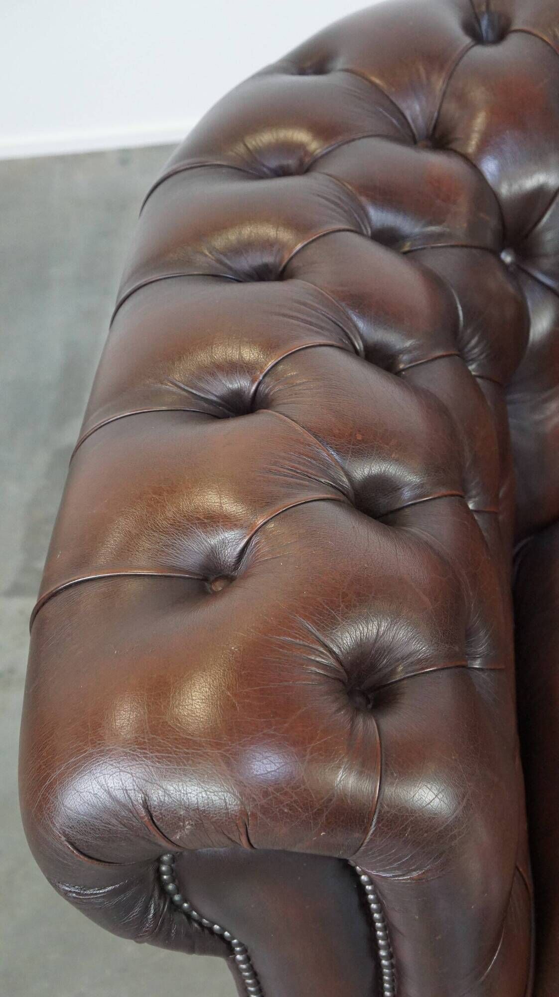 Beautiful and spacious dark brown mottled English cow leather Chesterfield armchair