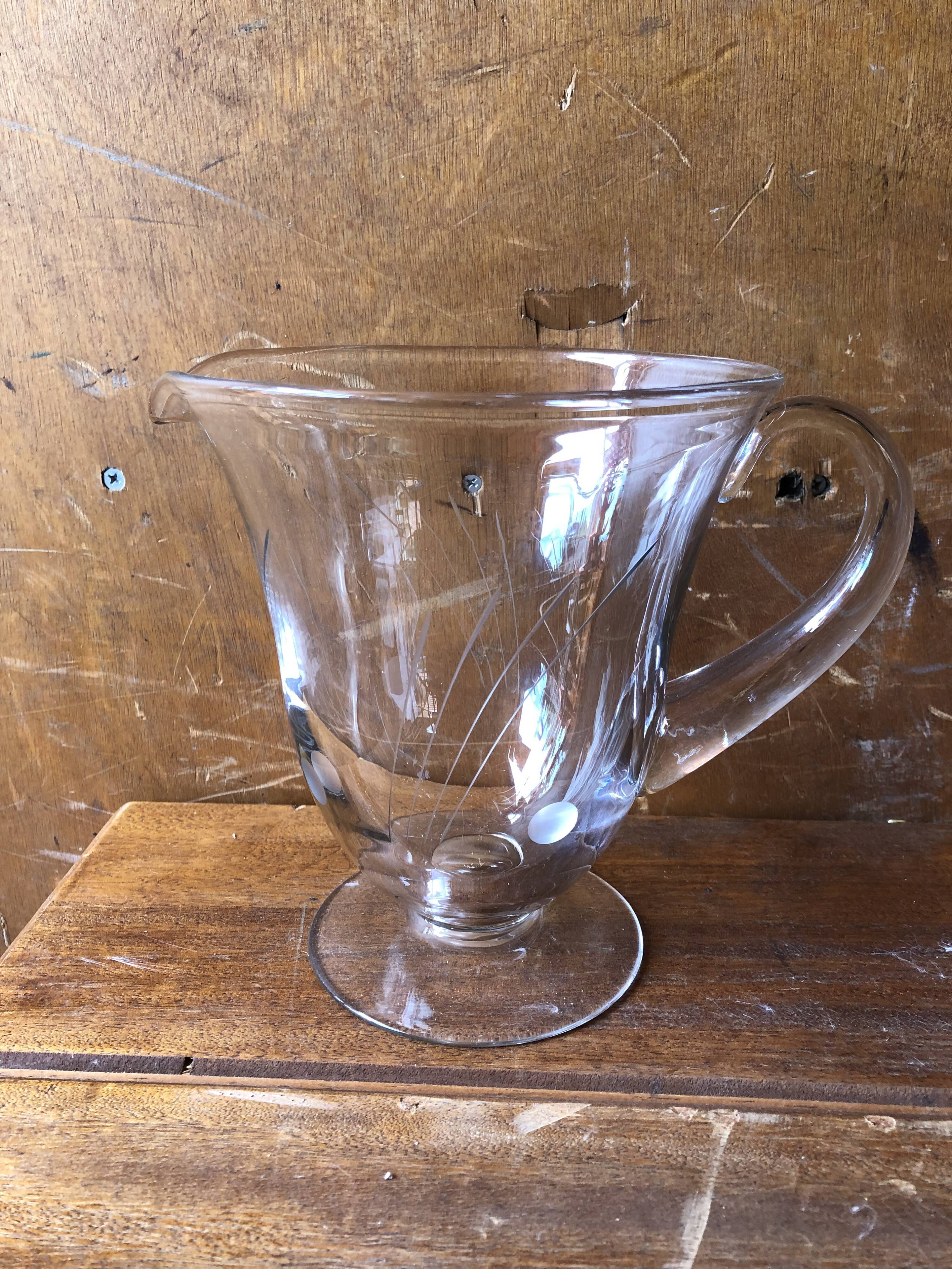 Old pitcher service and 5 foot glasses in engraved glass vintage table art