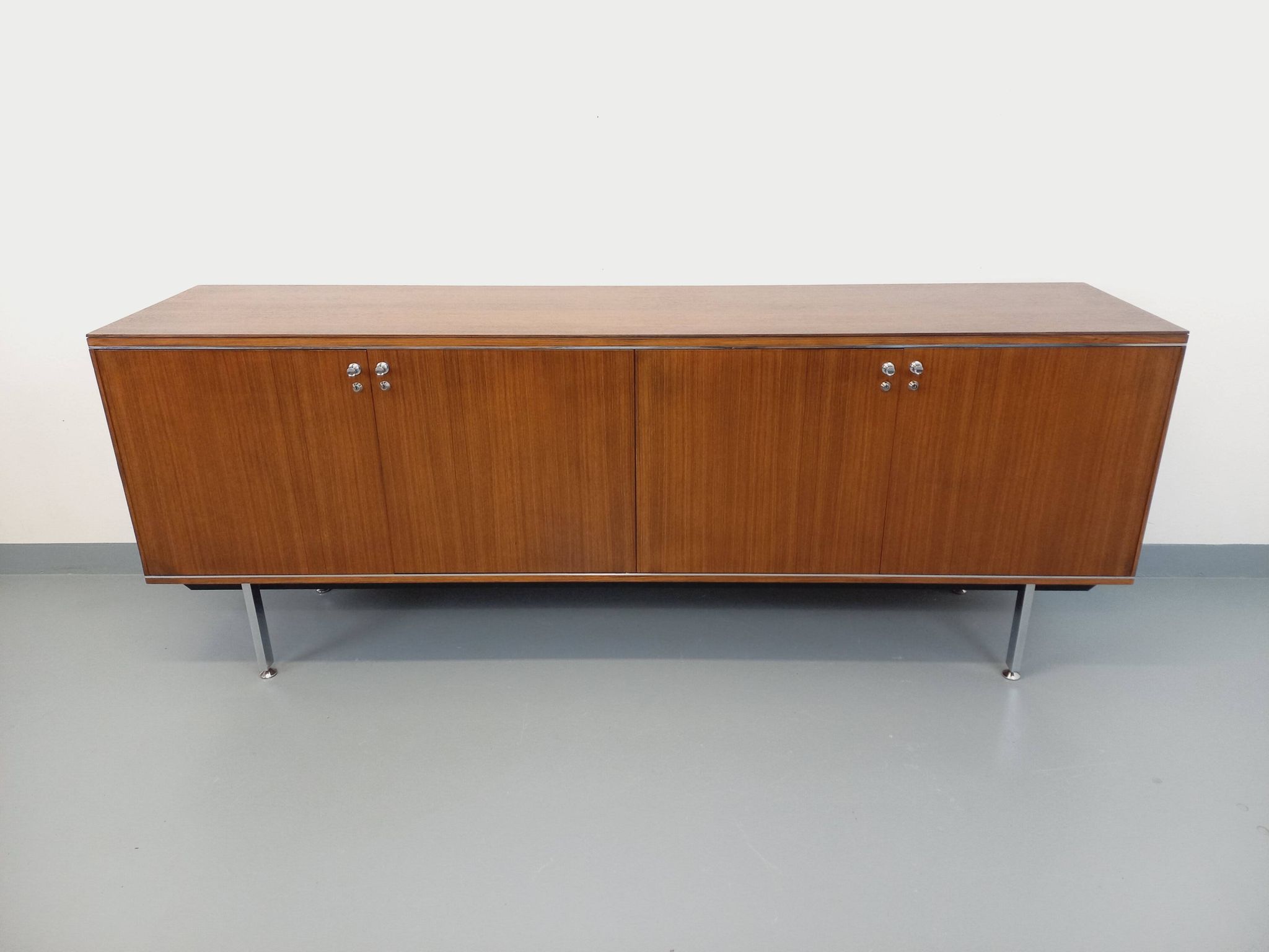 Vintage modernist enfilade in rosewood and chrome metal from the 60s and 70s.
