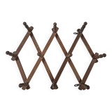 vintage wooden coat rack folds out like an accordion