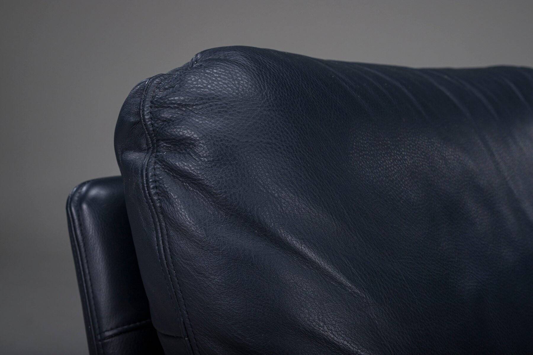 Danish teak and navy blue leather lounge chair from Komfort, 1970s