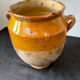 Old grease pot in glazed yellow terracotta, France nineteenth century